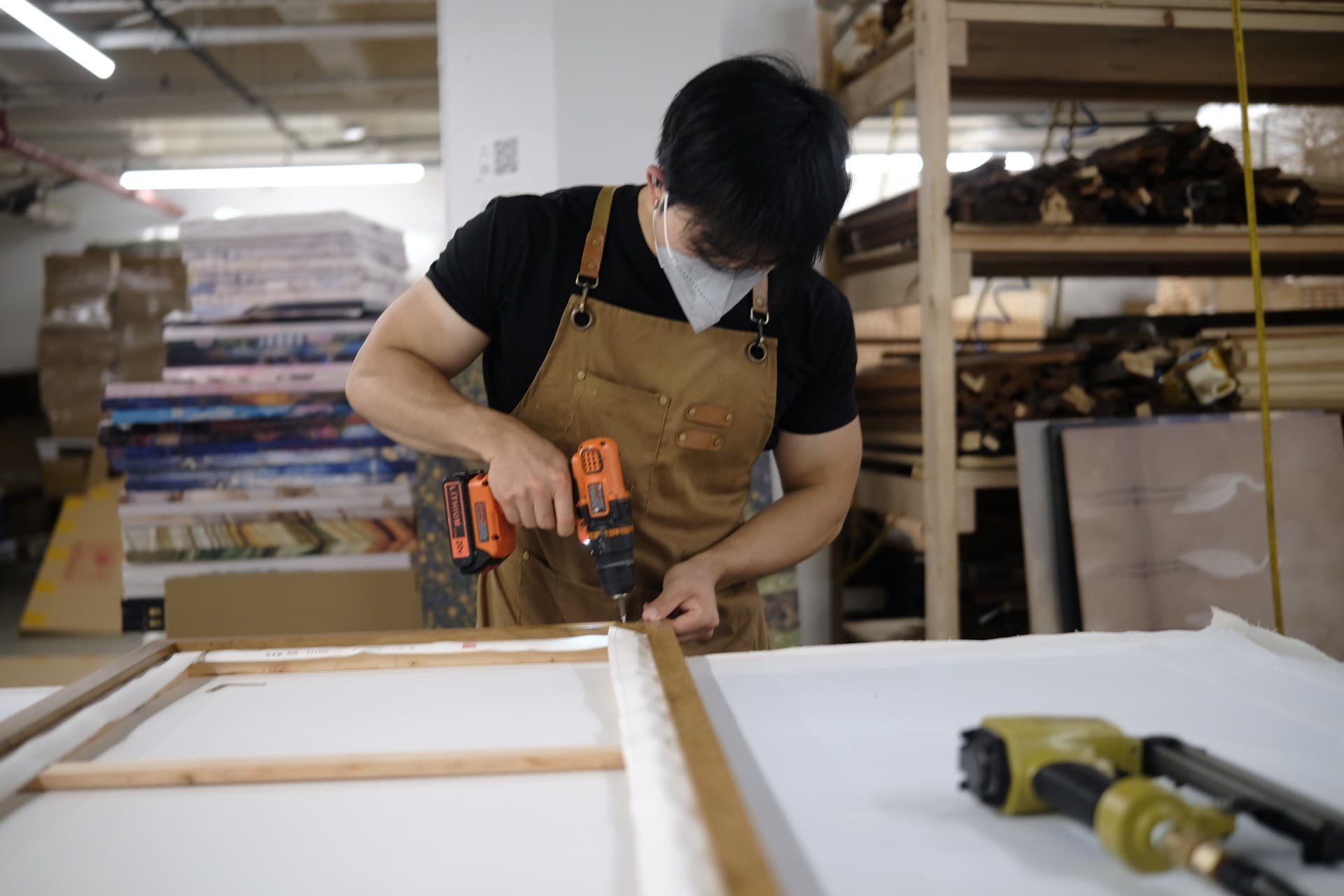 Craftsperson finishing a custom canvas in the Still Graphic studio