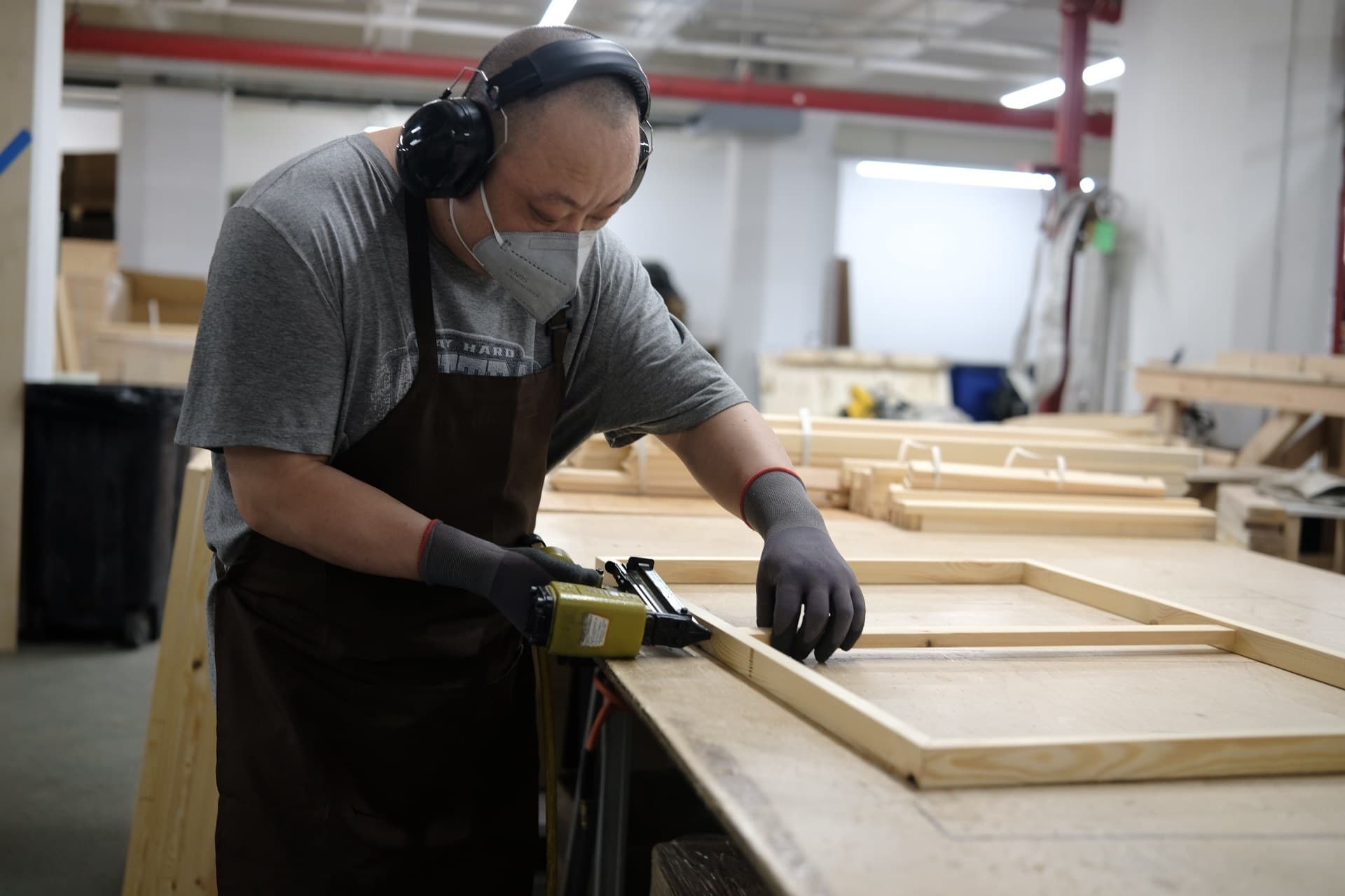 Craftsperson assembling a wooden canvas frame by hand